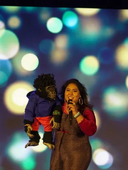 Another shot of me and Nikki on stage, with a bright and happy backdrop. We bring a professional and visually appealing show to every event.