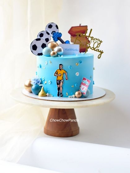 A different view of the "cake for him," showing the dumbbell and football toppers.