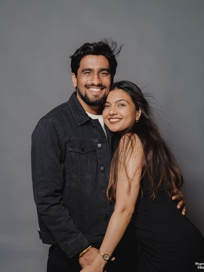 A happy, relaxed portrait of the couple. The wind in the bride's hair and their bright smiles give this pre-wedding studio shot a feeling of effortless joy.