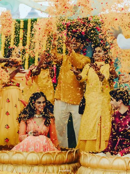 The same joyful Haldi moment, with the couple being showered in a rain of flower petals by their loved ones.