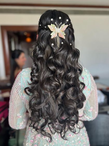 The full view of this beautiful half-up hairstyle, perfect for showing off long, curled hair.