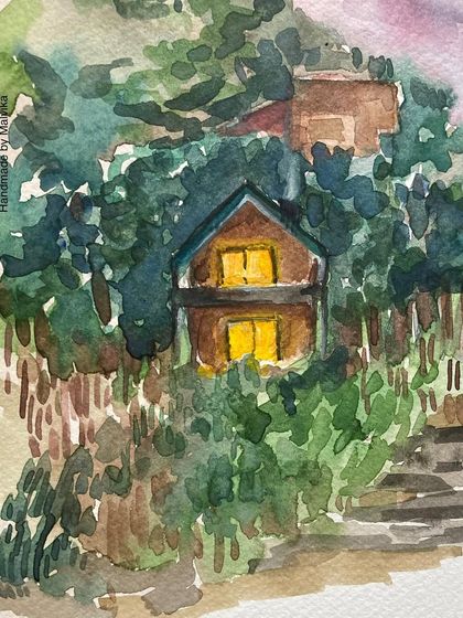 A close-up of the glowing mountain house. This detail highlights the warm yellow light in the windows, creating a strong contrast with the cool tones of the evening sky and surrounding trees.