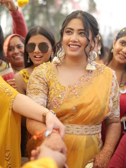 A candid shot of the bride during her Haldi ceremony, her smile radiating pure happiness.