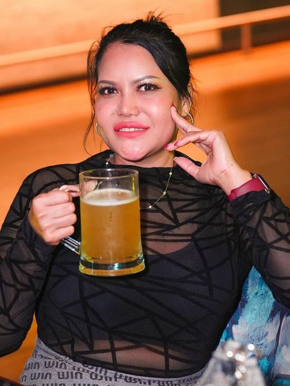 A guest enjoying a large mug of beer.