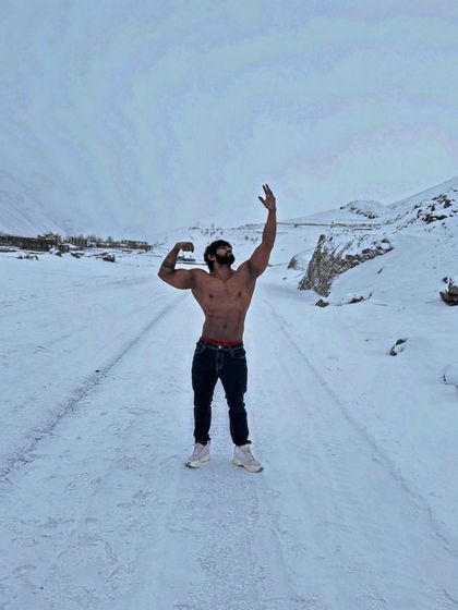 Travel far enough, you meet yourself. A classic pose on a snow-covered road in Spiti Valley. A moment of solitude and strength.