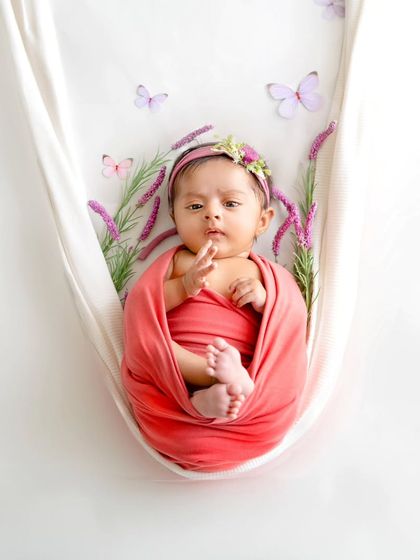 A sweet two-month-old baby wrapped and posed like a newborn. While the ideal time is 5-15 days, I can capture beautiful moments with slightly older babies too.