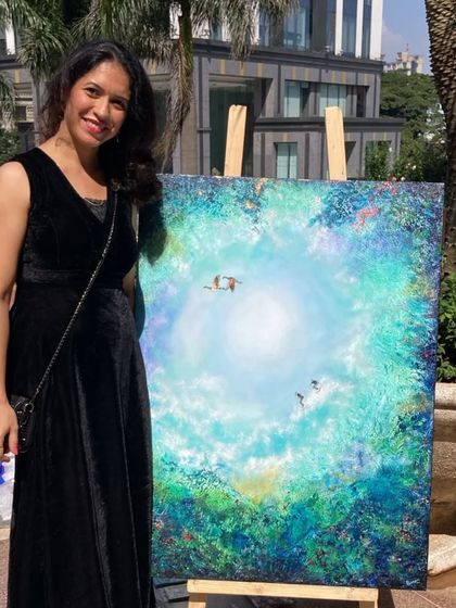 Artist Poonam with her beautiful celestial-themed painting at the 'Sublime Fiesta' in UB City.
