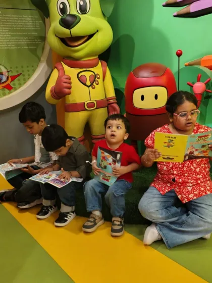 Our space isn't just for play. Here, a group of children enjoys a quiet moment reading books from our collection near the cafe.