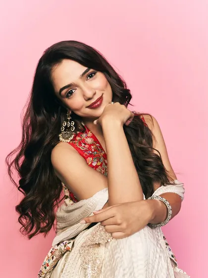 A soft and gentle portrait from the same Myntra series. The close-up allows the details of the embroidered jacket and the statement earrings to become the focus of the shot.