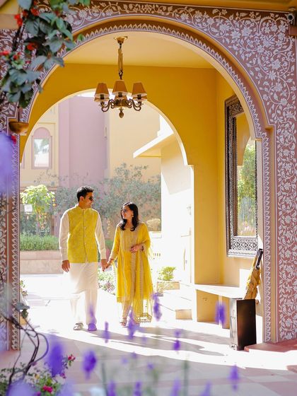 A candid moment during a pre-wedding shoot at a beautiful destination. The architectural arch frames their story perfectly.