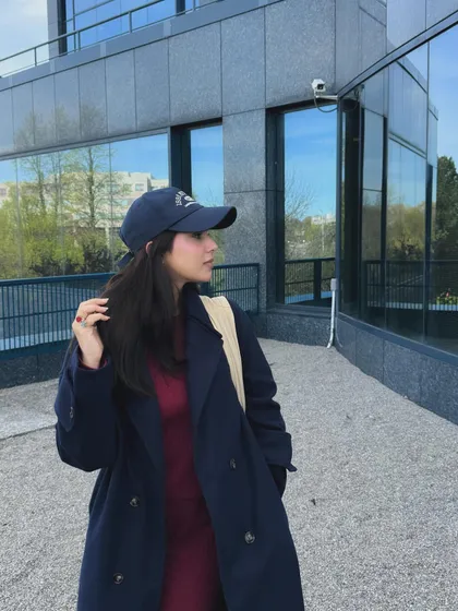A side profile of the same college look, showing how the trench coat and coord set look from a different angle.
