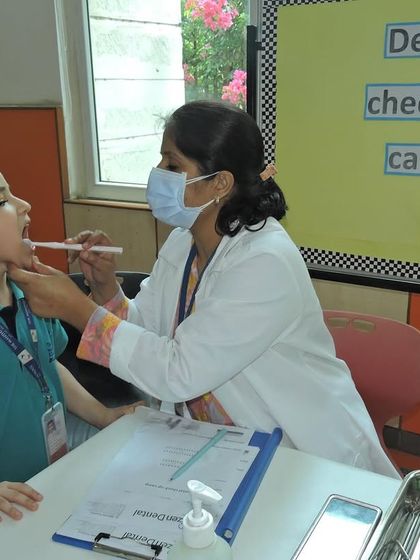 A student bravely gets his dental check-up. We create a comfortable and friendly atmosphere to make health check-ups a positive experience for children.