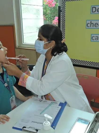 A student bravely gets his dental check-up. We create a comfortable and friendly atmosphere to make health check-ups a positive experience for children.
