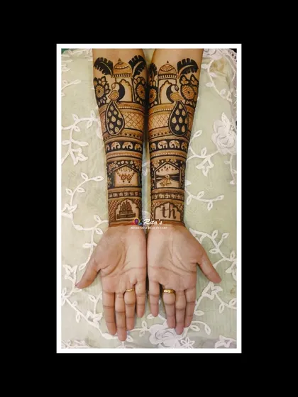 A full view of a Maharashtrian bridal design, showing the back of the hands. The patterns include peacocks, elephants, and architectural domes.