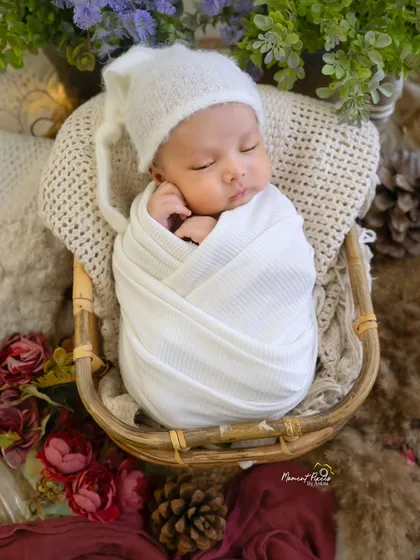 A perfectly wrapped newborn dreaming sweet dreams. These posed shots are best captured in the first couple of weeks, and they create such timeless art.