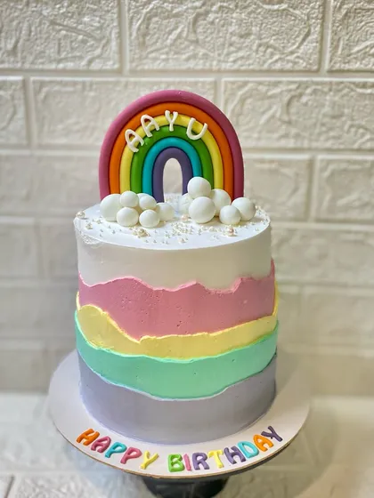 A full view of the cheerful rainbow cake, perfect for a happy birthday.