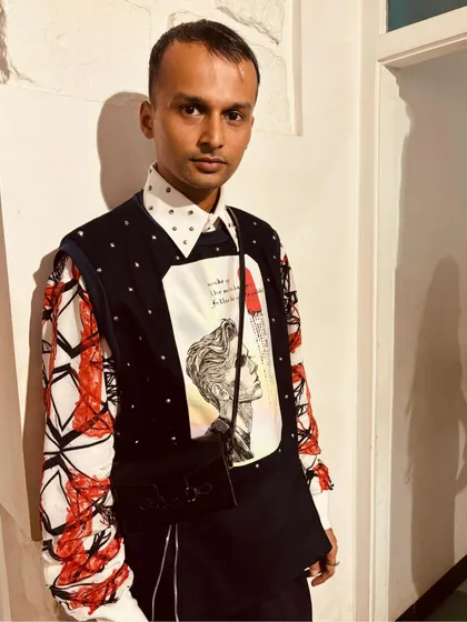 A close-up of the Matrix Set, showing the embellished collar shirt layered under the denim holographic printed pullover. It's a fusion of modern edge and artistic flair.