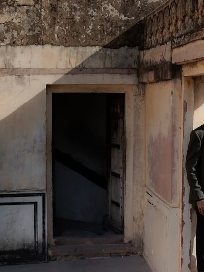 Using the rustic, weathered walls of a fort to create a dramatic and moody portrait. The contrast between the couple's modern style and the ancient setting makes for a powerful image.