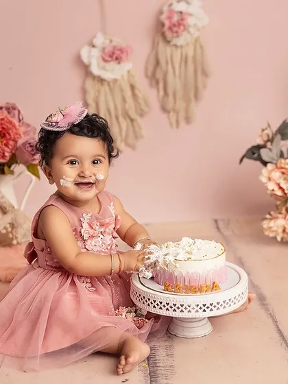 Look at that frosting-covered smile! A cake smash is all about letting them be little, and this precious girl enjoyed every moment of her beautiful, boho-chic birthday session.