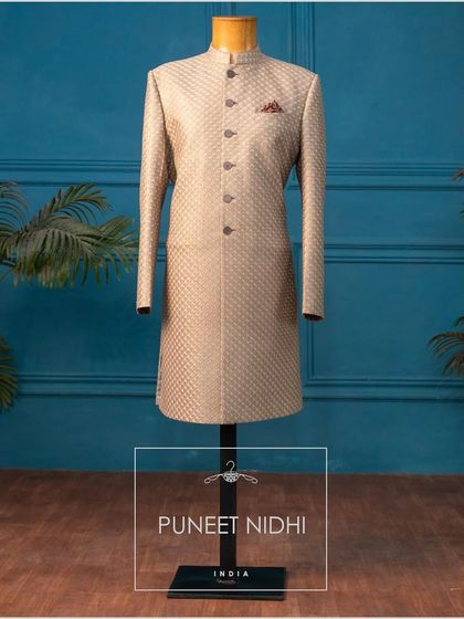 This Achkan, with its thread embroidery in a fish scale pattern, is a blend of simplicity and ethnicity, perfect for the discerning groom.