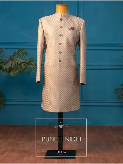 This Achkan, with its thread embroidery in a fish scale pattern, is a blend of simplicity and ethnicity, perfect for the discerning groom.