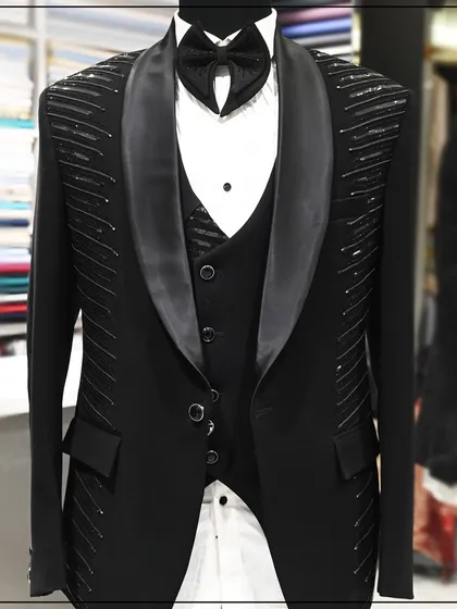 Another view of the black tuxedo with linear silver embroidery, showing the complete silhouette and tailored fit.