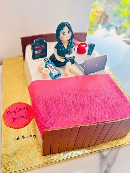 A custom bed-shaped cake featuring the birthday girl with all her favorite things.