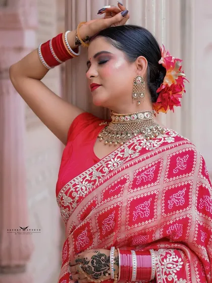 A close-up with the model's eyes closed, highlighting the bold makeup and traditional jewelry.
