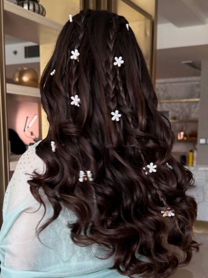 A full back view of the multi-braid half-up style, a unique and bohemian choice.