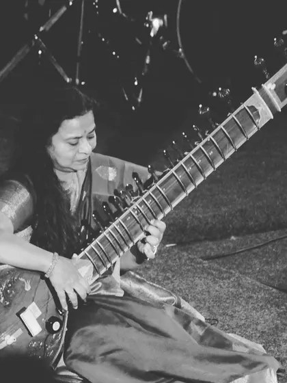 A black and white photograph capturing my focus during a live sitar performance on stage. In these moments, the world fades away and only the music remains.