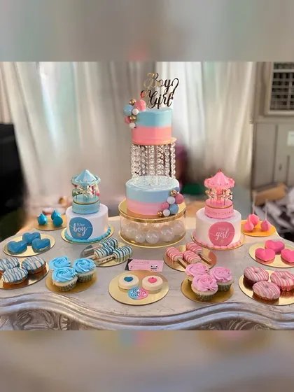 A full view of the beautiful pink and blue dessert table, perfect for a gender reveal party.