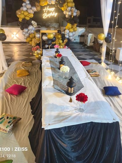 Another angle of the terrace canopy decoration, showing the complete layout with floor seating, a long table, and ambient lighting.