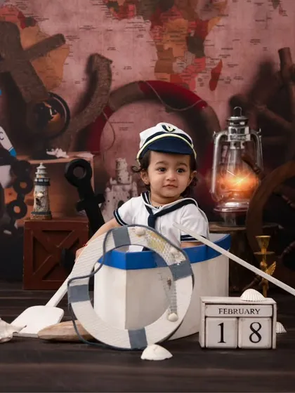 Ahoy, little sailor! This nautical-themed shoot is perfect for an adventurous little one, with props like an anchor, globe, and a mini boat.