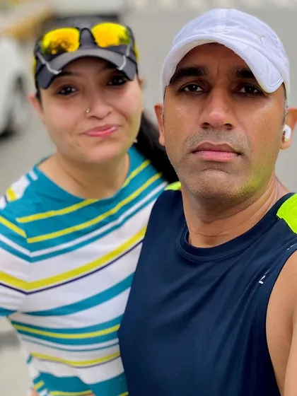 A couple from our running club posing for a selfie. We have many couples and families who join us, making it a true community.