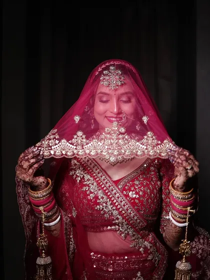 A playful and shy moment with the bride peeking through her veil.