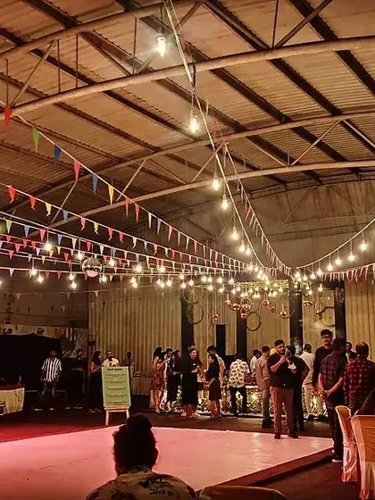 Guests mingling at a corporate party in our versatile indoor hall. The space can be configured with a mix of seating and standing areas to suit your event.