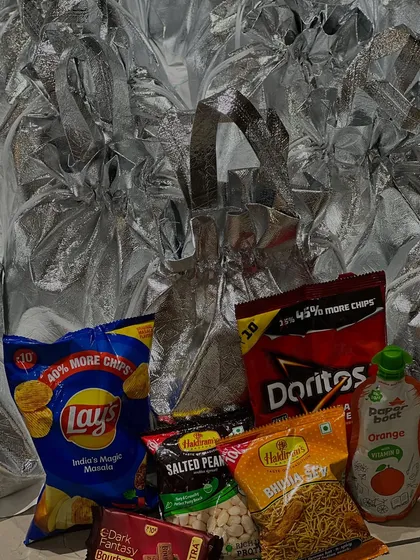 For a fun, no-fuss welcome gift, these metallic silver bags were filled with popular snacks like Lays, Doritos, and chocolates. It's the perfect midnight snack kit for guests after a long night of dancing.
