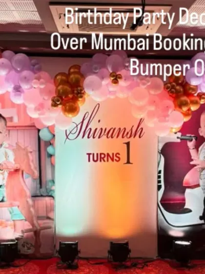 A large-scale Mickey Mouse themed stage decoration for a first birthday. This setup includes custom photo panels of the birthday boy, Shivansh, and Mickey Mouse character props.