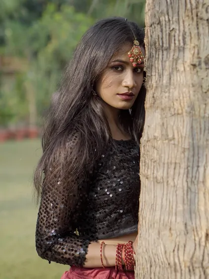 A more intense, direct-to-camera pose from the same ethnic fusion series. This highlights the model's expression and the details of her maang tikka.