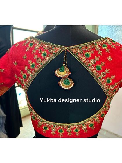 A full back view of the red blouse with the triangular keyhole opening, a popular choice for modern bridal wear.