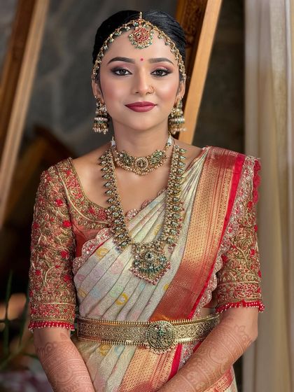 A smiling portrait of the bride, showing how the makeup enhances her natural beauty. The look is classic, elegant, and perfect for a traditional wedding.