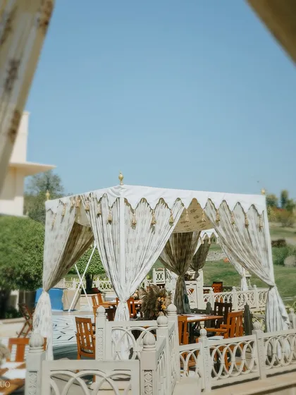 An elegant dining cabana with printed drapes, overlooking the festival-themed lawn. This provided a more intimate and shaded space for guests to enjoy their lunch.