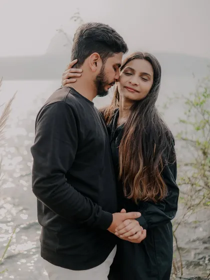 A gentle, loving embrace with the beautiful lake behind them. The soft light and their peaceful expressions make this a very warm and romantic photograph.