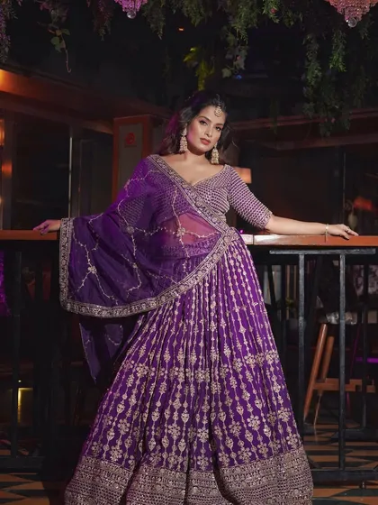 A full-length shot showing the grandeur of this reception outfit. The makeup is bold enough to balance the intricate details of the lehenga.