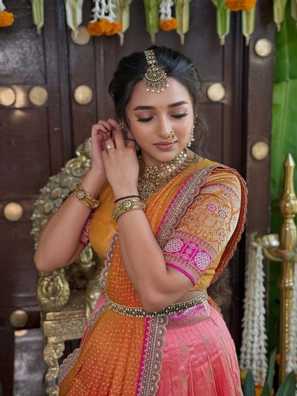 A candid moment that highlights the delicate details of the outfit and the client's graceful posture.