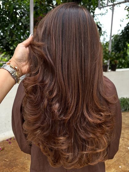 A beautiful color refresh for this client, getting her vacay-ready. I added soft, natural-looking highlights to her long hair and finished with a layered cut and bouncy curls for a glamorous feel.