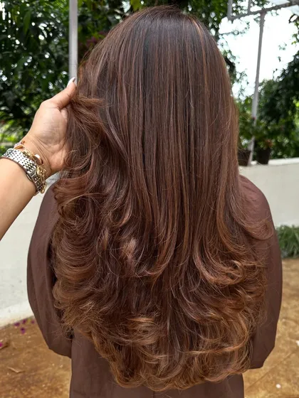 A beautiful color refresh for this client, getting her vacay-ready. I added soft, natural-looking highlights to her long hair and finished with a layered cut and bouncy curls for a glamorous feel.