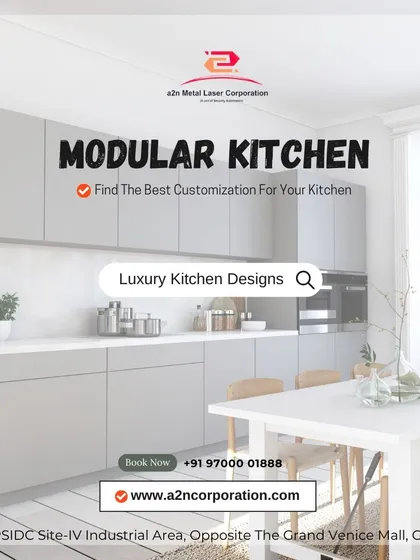 A minimalist modular kitchen design in a light grey finish. The handleless cabinets and clean lines are ideal for creating a serene and uncluttered cooking environment, complemented by a simple dining setup.