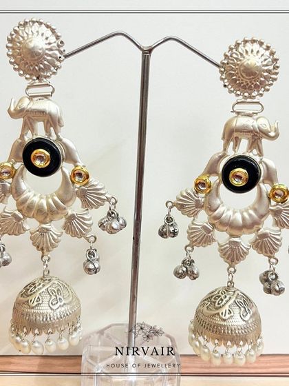 Intricate silver jhumkas with elephant motifs, showcasing traditional designs with a contemporary twist.