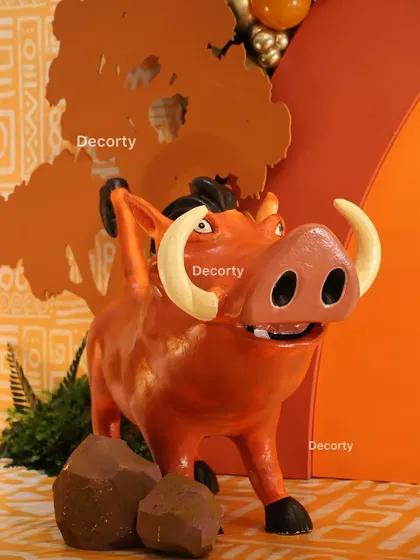 A detailed close-up of the Pumbaa statue, showing the craftsmanship that goes into each prop.